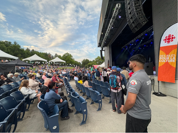 G Force security guard watching over a crowd at an outdoor concert venue