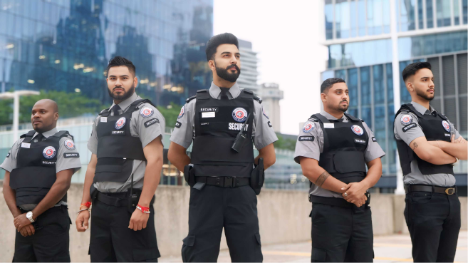 A team of uniformed G Force security guards standing outside a commercial building