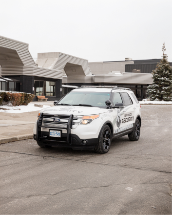 G Force Security mobile patrol vehicle parked outside a building