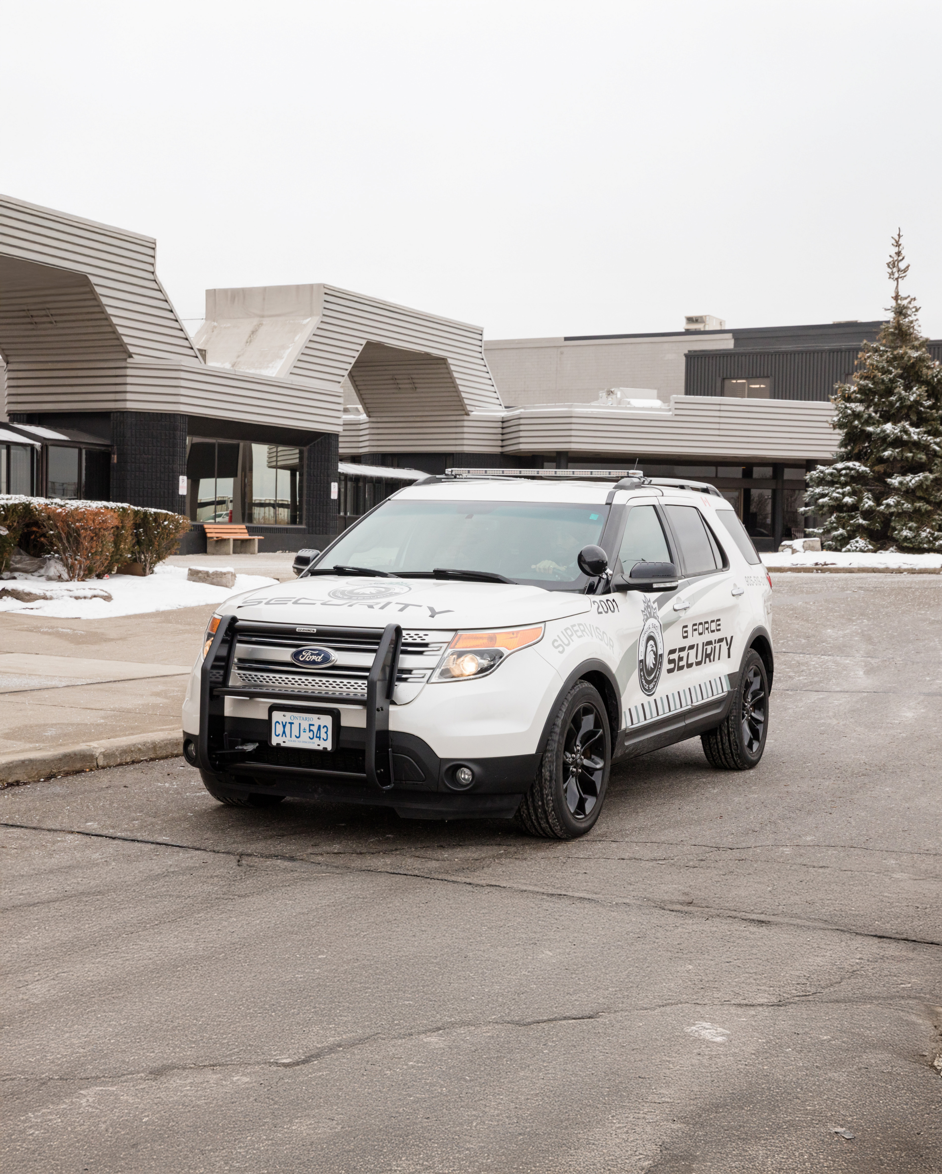 G Force Security mobile patrol vehicle parked outside a building