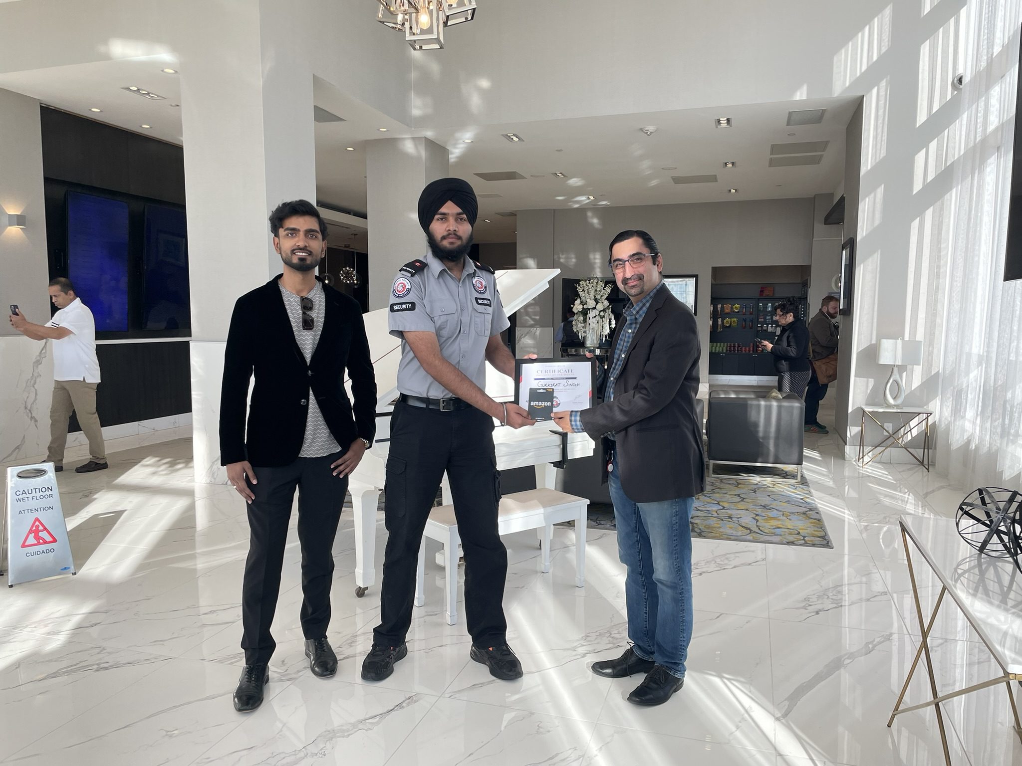 G Force Security team members with a uniformed security guard at a company presentation.